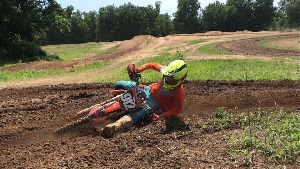 Motocross rider leaning into a fast dirt corner